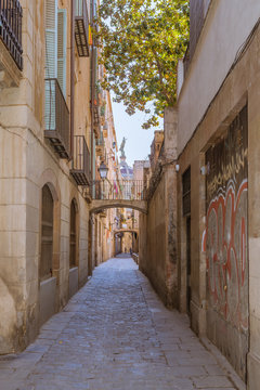 Narrow streets and alleys in the Ciutat Vella, the historic part of Barcelona. The lane leads to the church Basilica of Our Lady of Mercy, Basílica de la Merce  