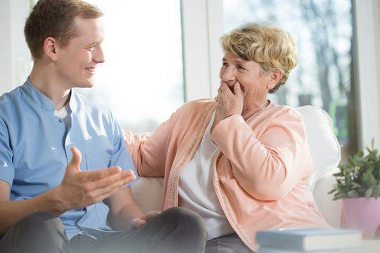 Man and elderly woman laughing