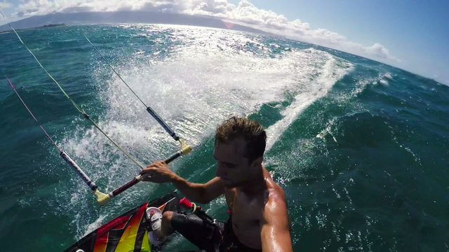 POV Shot of Young Mzan Kite Surfing and Catching Air in Hawaii. Slow Motion HD.