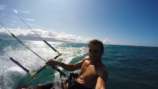 POV Shot of Young Happy Man Kite Boarding in Hawaii. Extreme Summer Sports in Slow Motion.