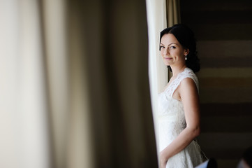 beautiful bride standing at the window