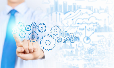 Businessman activating gears mechanism