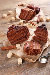 Slices of tasty chocolate cake on table, close-up