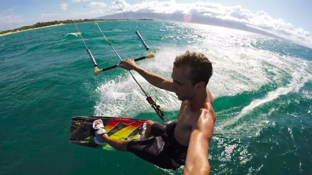 Extreme POV Shot of Young Man Kiteboarding on a Beautiful Sunny Day in Hawaii. Slow Motion HD.