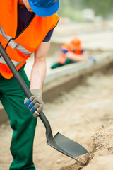 Construction worker holding shovel