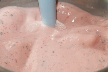 Mixing strawberry cream with selective focus