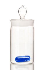 Transparent jar with pill isolated on white