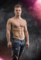 Fototapeta na wymiar Handsome young bodybuilder in relaxed pose