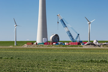 Farmland with construction work at the biggest windfarm of the Netherlands
