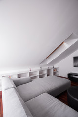 Fototapeta na wymiar Comfortable sofa in attic