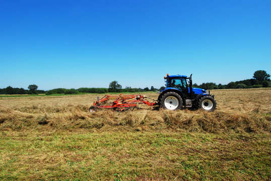 GERMANY  - Farmer turns hay in summer