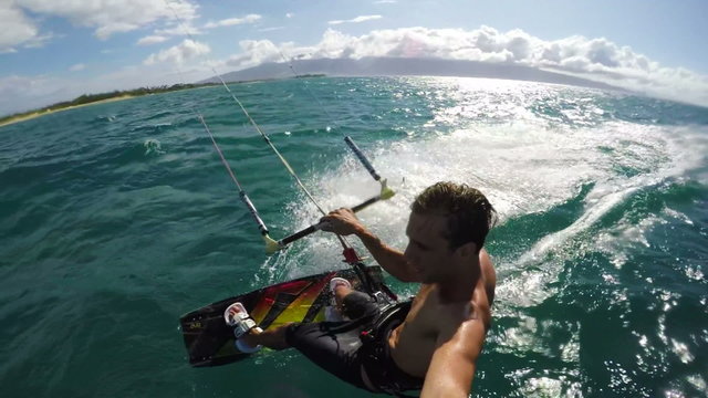 Extreme POV Kiteboarding. Young Man Cruises Along the Water.