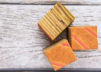 Malaysian dish Kek Lapis Sarawak or Sarawak layered cake over wooden background