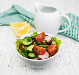 Spring salad with tomato, cucumbers and radish