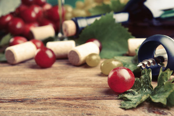 Wine bottle corks with grapes on table close-up