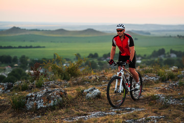 Fototapeta premium Biker riding on bicycle in mountains