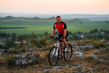 Fototapeta premium Biker riding on bicycle in mountains