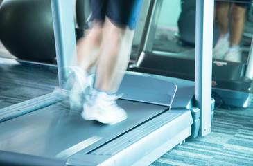 Woman running with motion of speed by treadmill