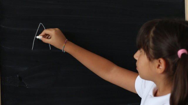 Little girl writing ABC on a chalkboard - Powered by Adobe