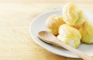 Choux Cream, Cream puff on wooden table, selective focus and vin