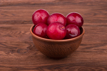 Red plums in a bowl