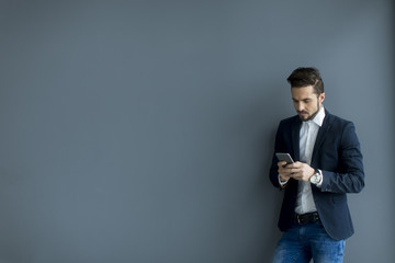 Young man with mobile phone in the office