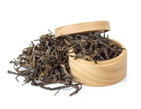  dry tea in wooden bowls. Isolated on white background