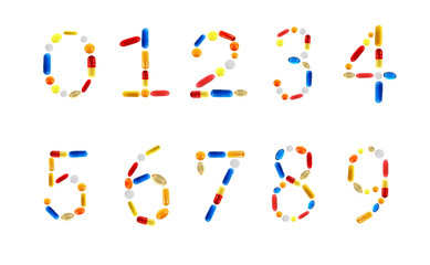 Numbers made with pills isolated on white