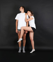 Fototapeta premium Funny young couple on black background