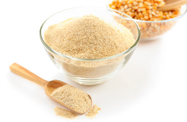 Glass bowls with flour and corn grains isolated on white