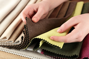 Woman chooses scraps of colored tissue on table close up