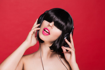 Woman listening to music on headphones enjoying a dance. Dj