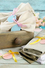 Napkins with Easter decorations  on color wooden background