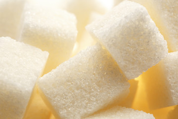 Cubes of white sugar in closeup background
