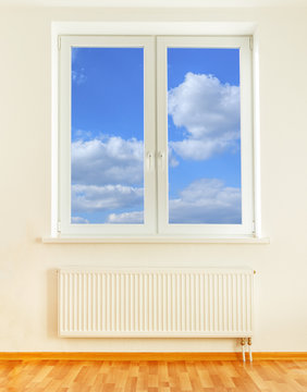 Radiator and window with blue sky view