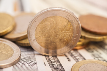 Euro coins over dollar notes