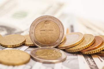 Euro coins over dollar notes