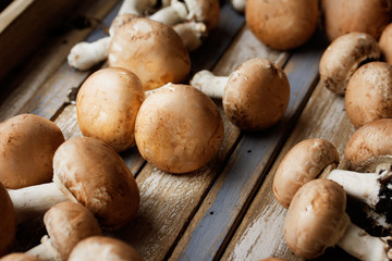 Portobello mushrooms on rustic wooden desk.