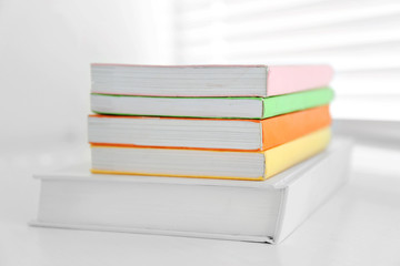 Books on white windowsill, close up