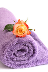 Obraz na płótnie Canvas isolated lilac towel with yellow rose with copy space 
