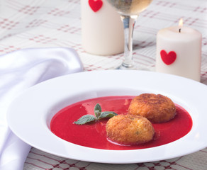 Strawberry soup with italian fried rice balls arancini.