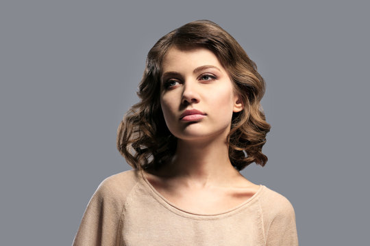 Portrait of beautiful model on gray background