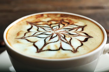 Cup of latte art coffee, closeup