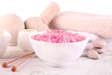 Spa still life with color sea salt on wooden table, closeup