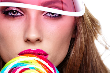 Beauty summer model girl Eating colourful lollipop.