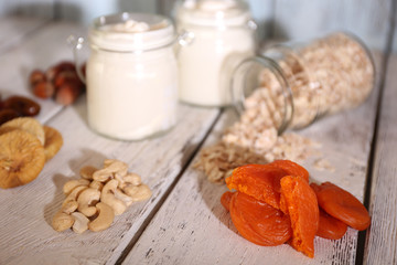 Healthy breakfast with dried fruits and nuts on color wooden background