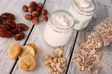 Healthy breakfast with dried fruits and nuts on color wooden background