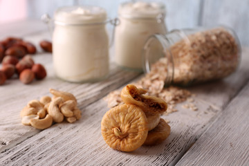 Healthy breakfast with dried fruits and nuts on color wooden background