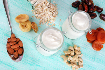 Healthy breakfast with dried fruits and nuts on color wooden background
