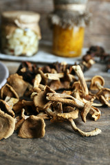 Dried mushrooms with spices on wooden table, closeup